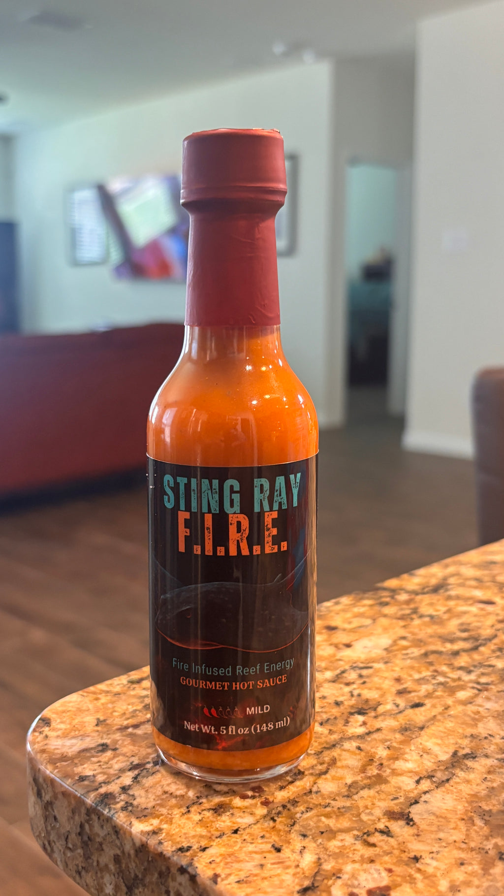 Stingray F.I.R.E 5 oz bottle on a cabinet top.