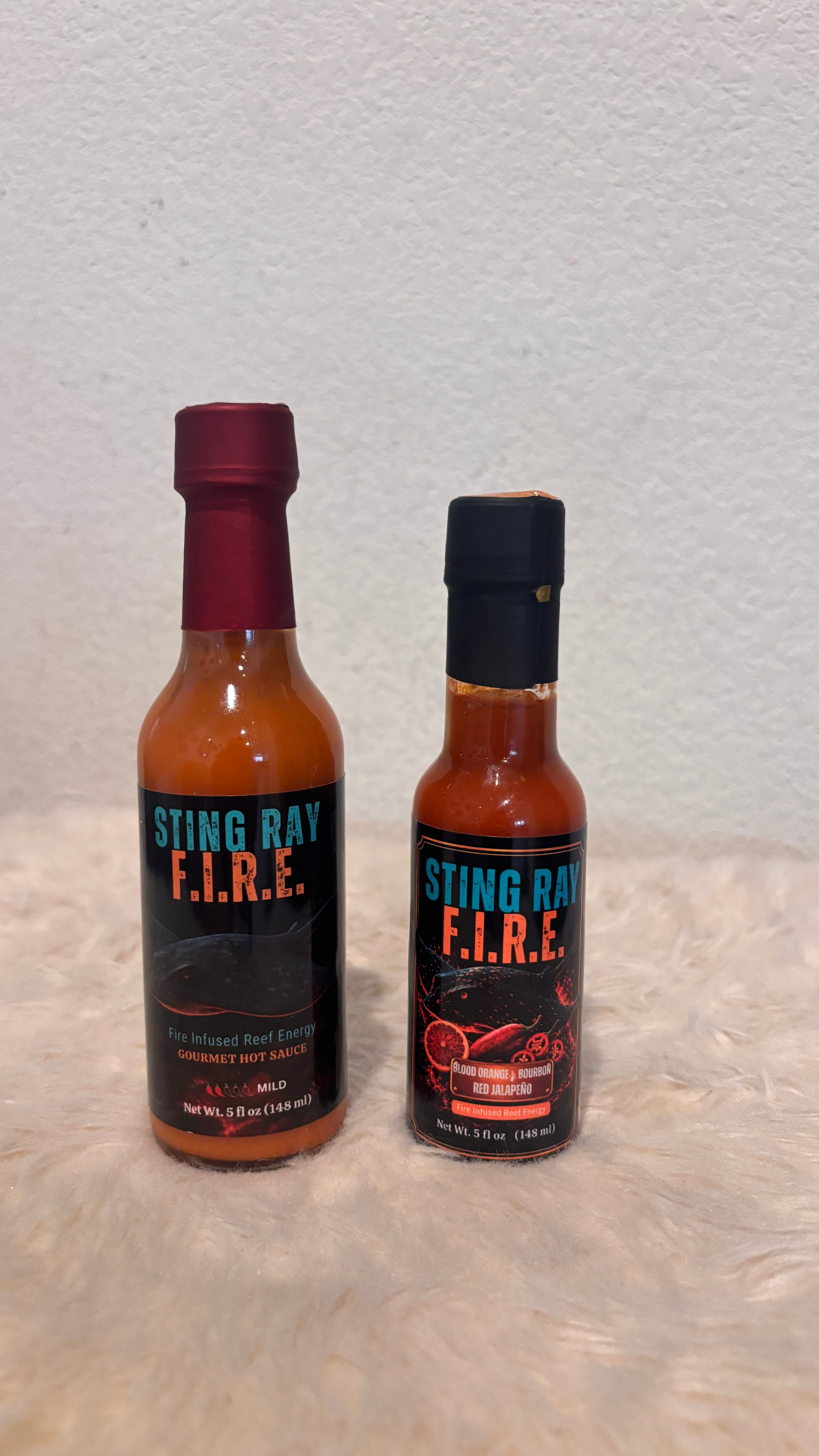 Sting Ray F.I.R.E. hot sauce shown in full-size and smaller sample bottles